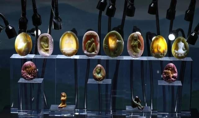 Award-winning Yanyuan agate carving "Song of Youth" showing intricate multicolored details.