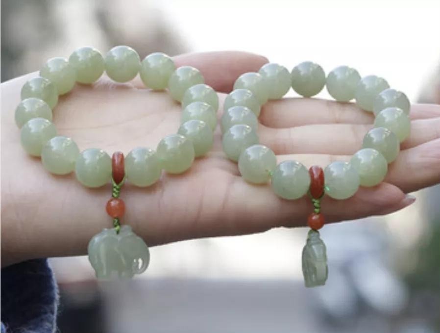 A pair of standard green nephrite bead bracelets marketed as Cui Qing.