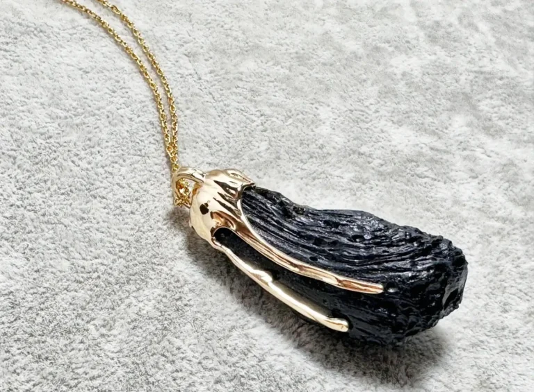 18K gold pendant necklace featuring a polished black Hainan tektite gemstone.