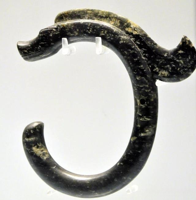 A C-shaped Xiuyan jade dragon from the Hongshan Culture, known as the "First Dragon of China."