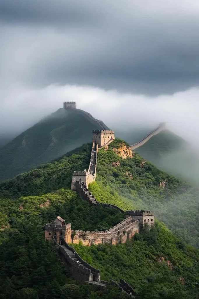 Aerial view of Jinshanling Great Wall in Hebei winding through mountains and mist.