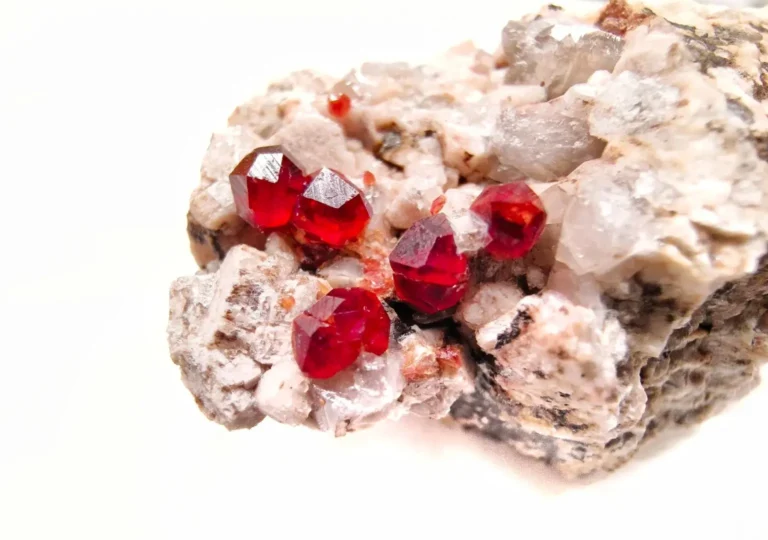 Five red garnet crystals embedded in natural host rock from Mingxi, Fujian.