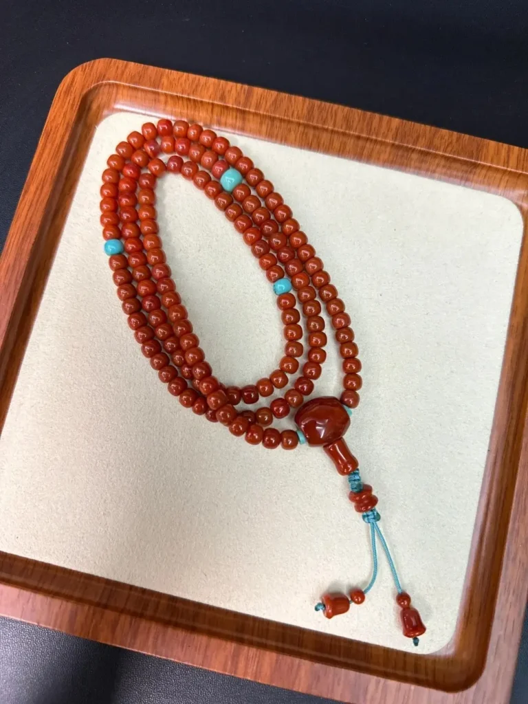 108-bead Nanhong necklace with vibrant turquoise spacers and a matching guru bead.