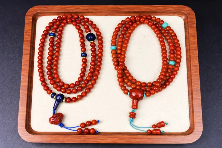 Two 108-bead Nanhong necklaces side-by-side, accented with turquoise and lapis lazuli.