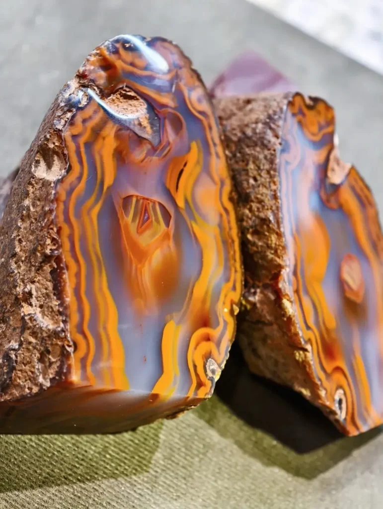 Polished Zhan-Guo Red agate halves with natural owl and rose patterns, from the "Gemstones of Hebei" series.