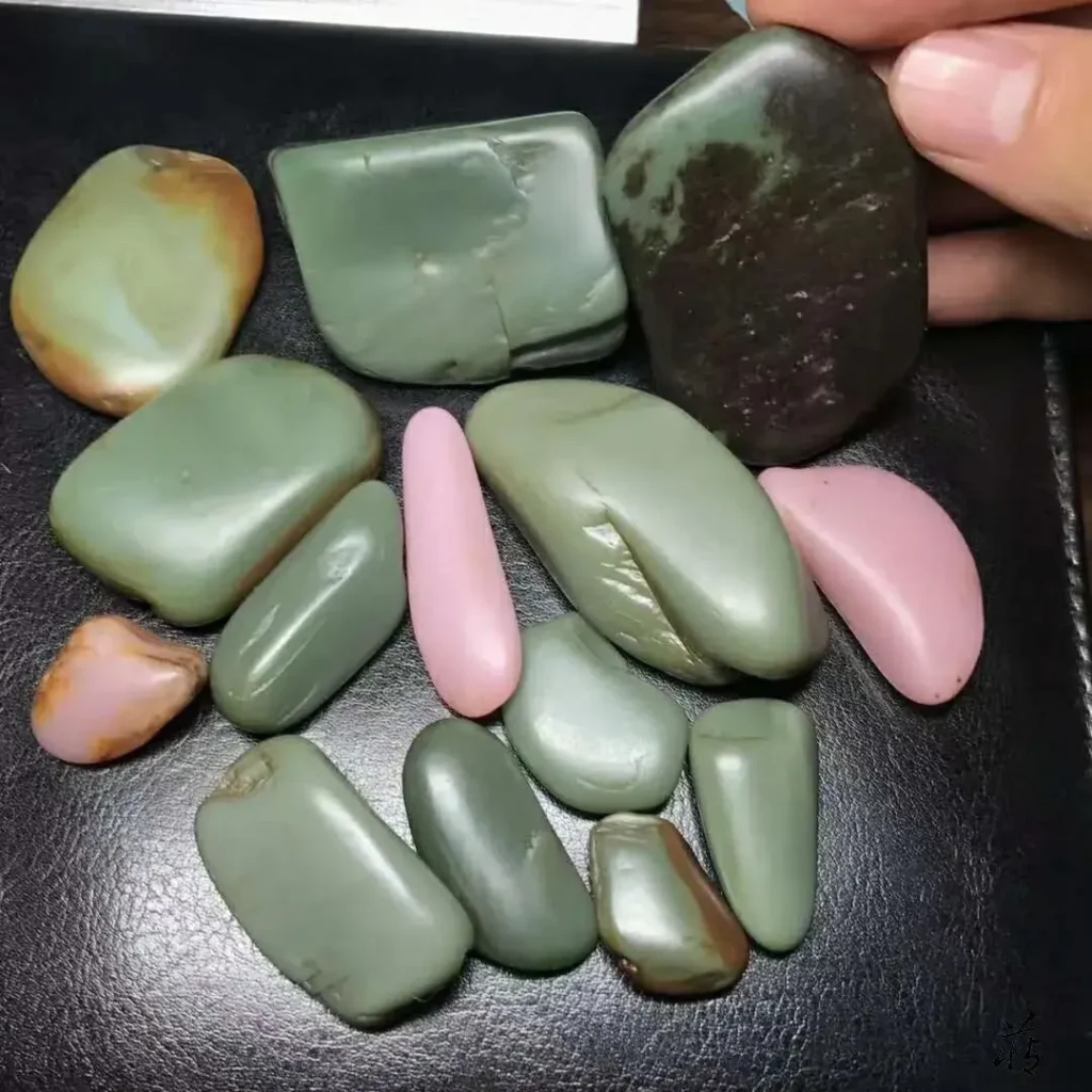 A group of Anthophyllite stones showing distinct pink violet and greenish-blue Sha-zao-qing colors.