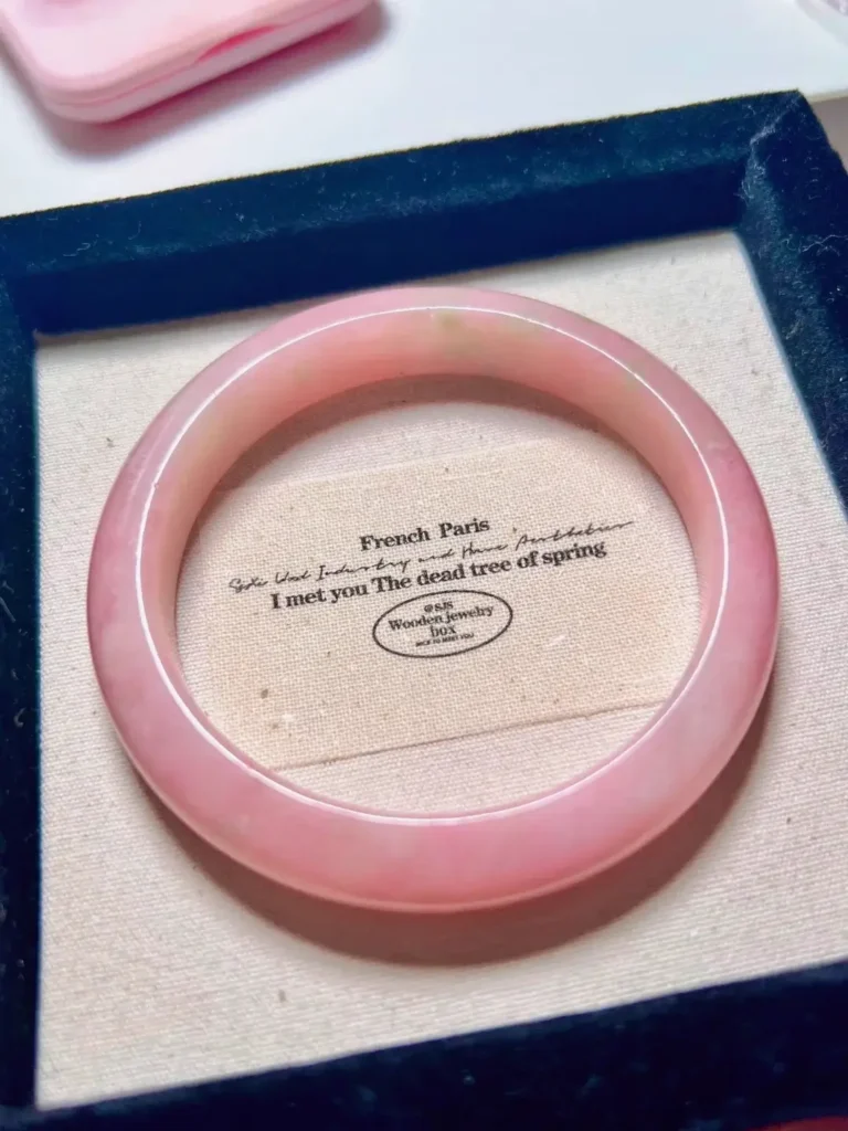 Polished pink Anthophyllite Jade bracelet showing a soft lavender hue and silky mineral luster.