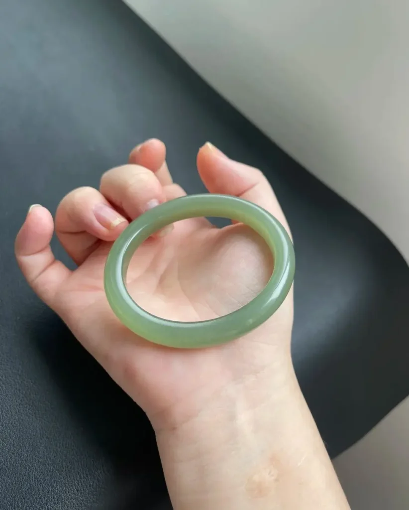 A size 53 oval-shaped Qinghai nephrite jade bracelet in a translucent Lake Green hue.