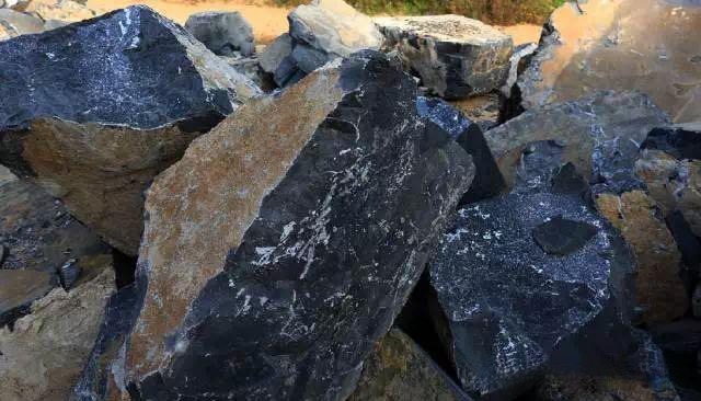 Raw Shaanxi Fuping Black Stone specimens with deep cyan to ink-black hues and visible textures.