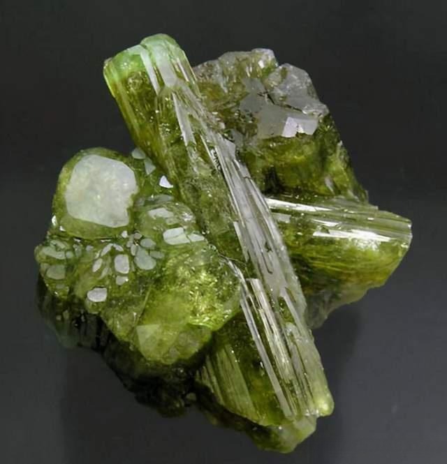 A green Vesuvianite crystal specimen showing distinct columnar structure and vitreous luster.