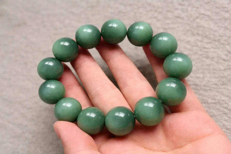 A dense Sha-zao-qing Nephrite Jade bracelet with a thick, oily, and "skin-like" texture.