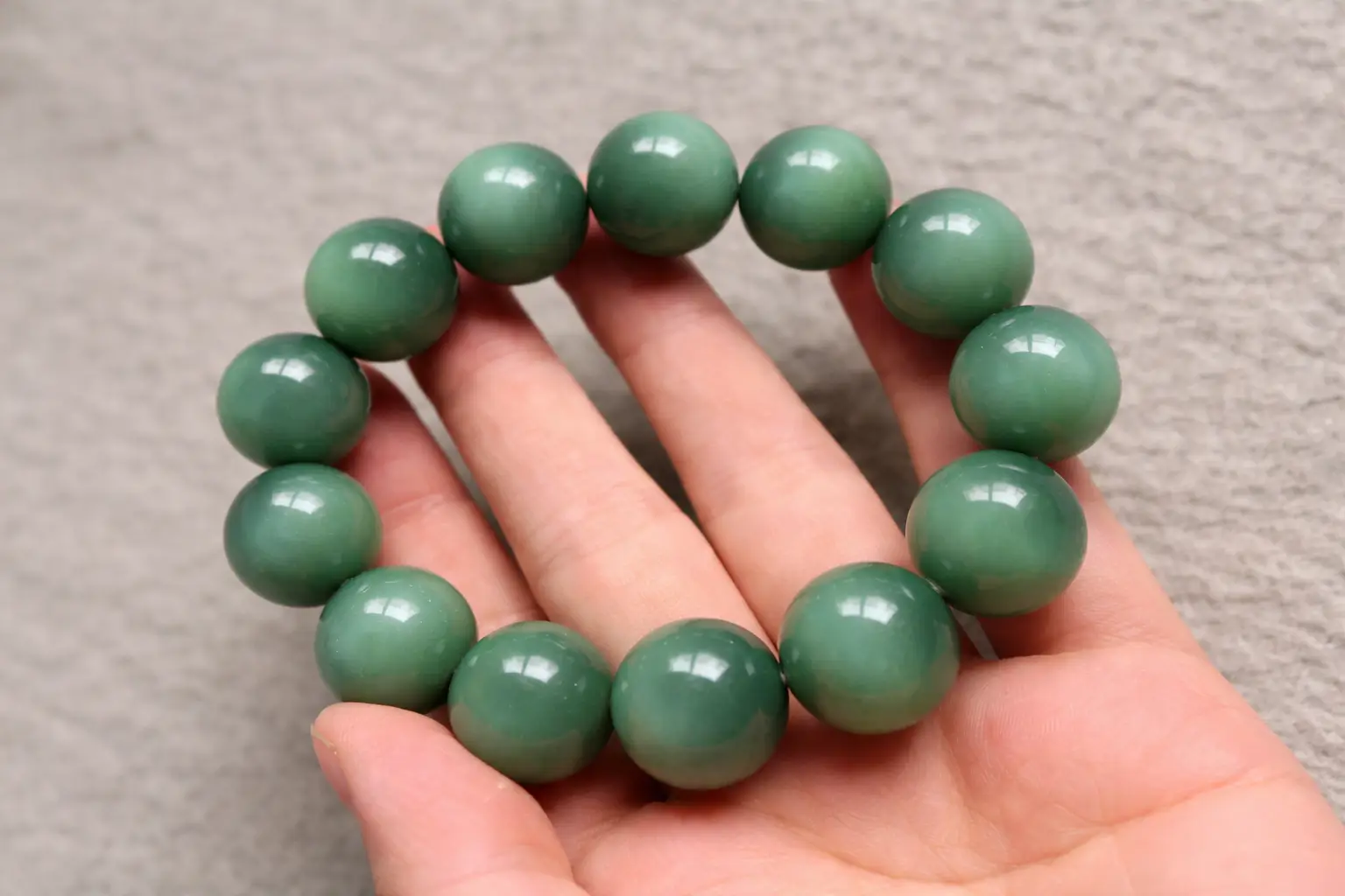 A dense Sha-zao-qing Nephrite Jade bracelet with a thick, oily, and "skin-like" texture.