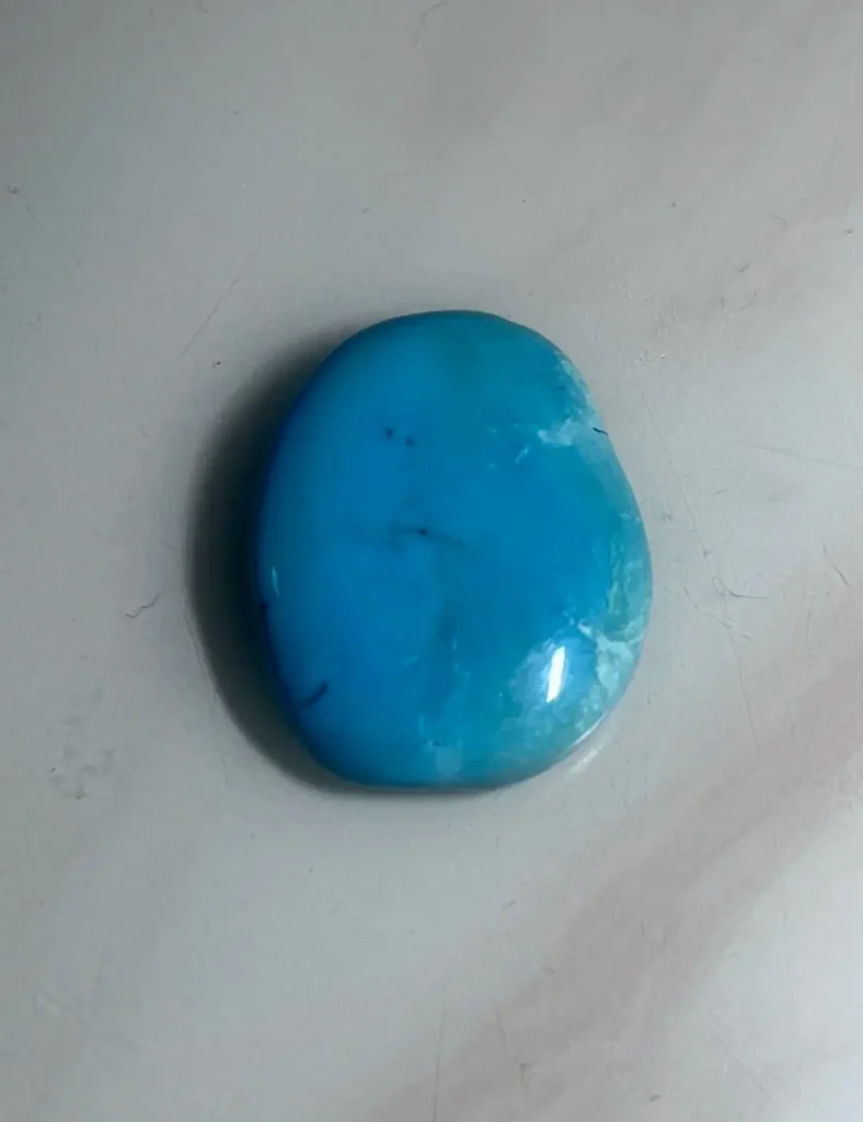 A 6.5g Shaanxi Baihe turquoise stone showing sky-blue color and a unique semi-translucent oily luster.