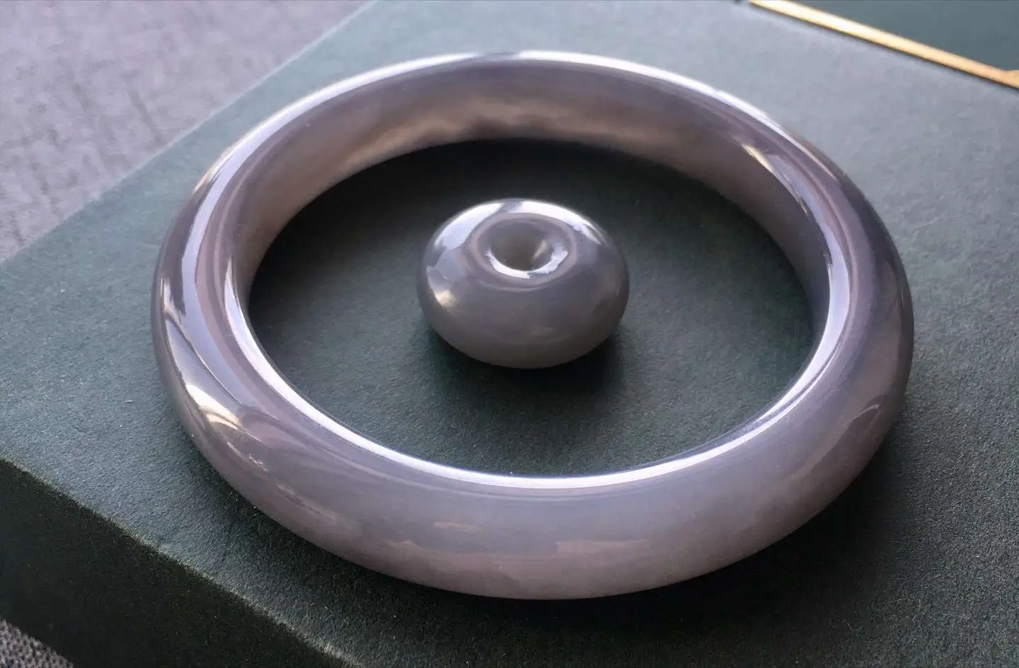 Smoky purple nephrite jade bangle and ping'an kou pendant set with smooth, oily violet-grey finish.