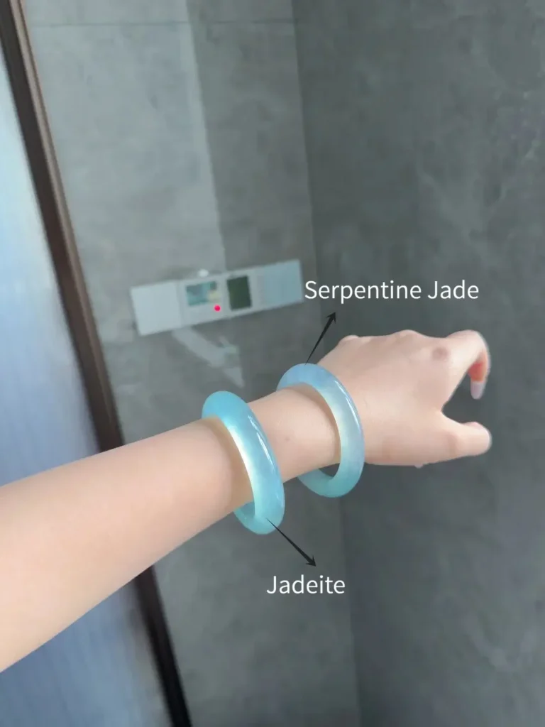 Side-by-side comparison of Tianqingdong and Blue Water Jadeite bangles on a person's wrist.