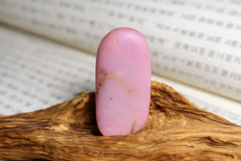 A high-quality pink Anthophyllite jade stone with vibrant violet-pink hues and a silky luster.