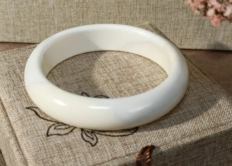Porcelain white silicified magnesite bangle from Tibet with semi-translucent, fine-grained texture.