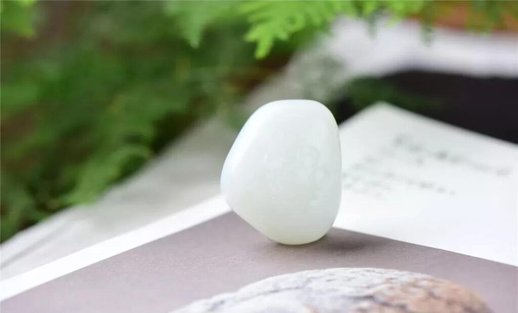 White Hetian Nephrite lotus pendant featuring a fine-grained, translucent texture.
