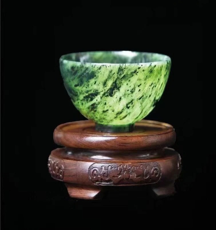 Light green Yuanyang Jade luminous cup from Gansu with natural black mottled patterns.