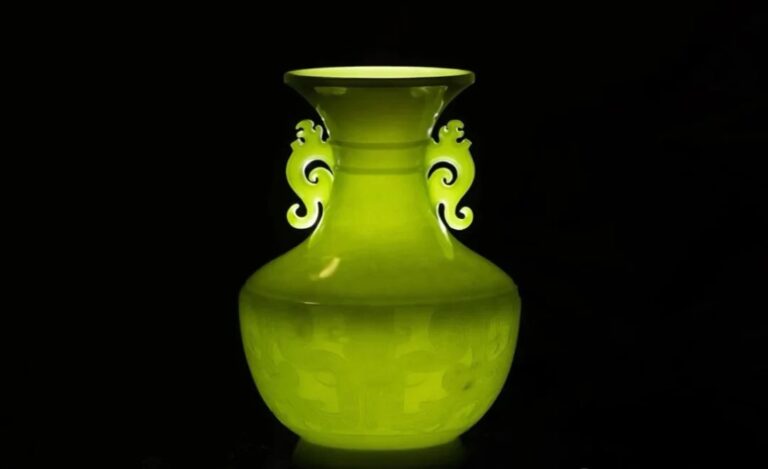Thin-walled Ximu Jade vase featuring ancient Taotie and Kui dragon totems.
