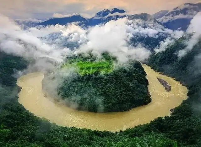 Aerial view of a massive horseshoe-shaped river bend in the Yarlung Tsangpo Canyon, Tibet.