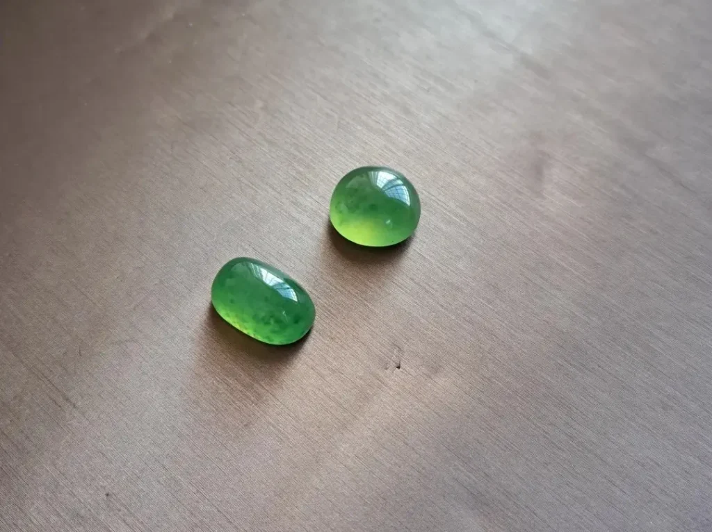 Two translucent yellow-green Vesuvianite Jade cabochons with brilliant vitreous luster.