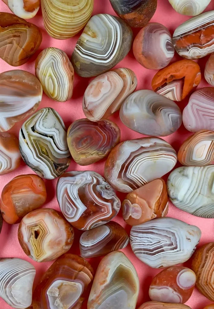 A polished Hubei Yichang agate featuring red-brown gradients and wavy silk-banded patterns.