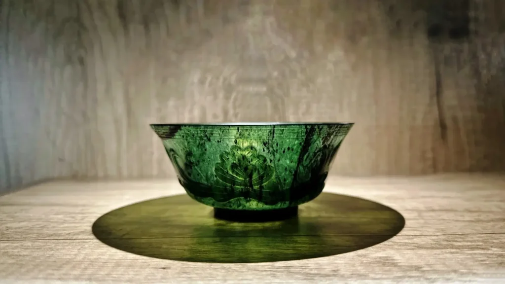 Translucent green Yuanyang Jade bowl from Gansu, China, with natural dark serpentine mottling.