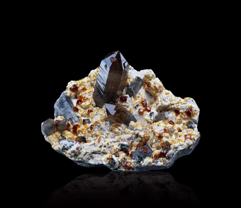 Smoky quartz crystals with orange spessartine garnets and feldspar from Yunxiao, Fujian.