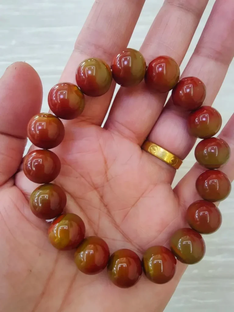 Zhanguo Red Agate bead strand featuring vibrant red and yellow banding patterns.