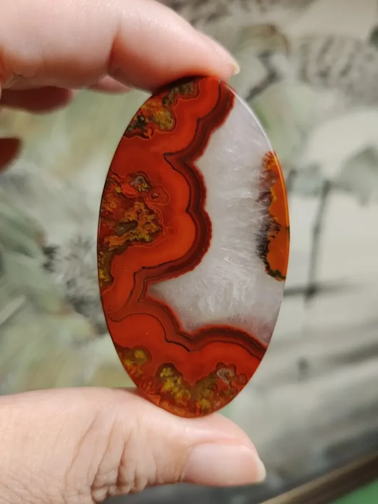 Rare Zhan-Guo Red agate with layered red bands and a centered crystalline explosion pattern.