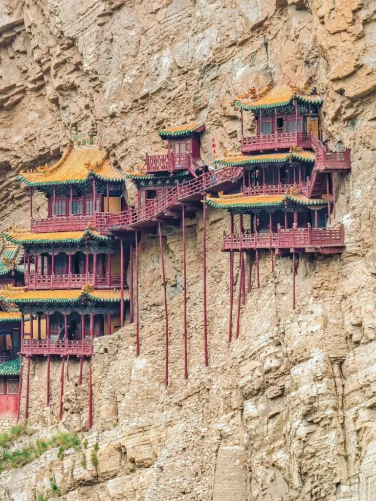 Ancient wooden Hanging Temple built into a steep sandstone cliff in Mount Heng, Shanxi.