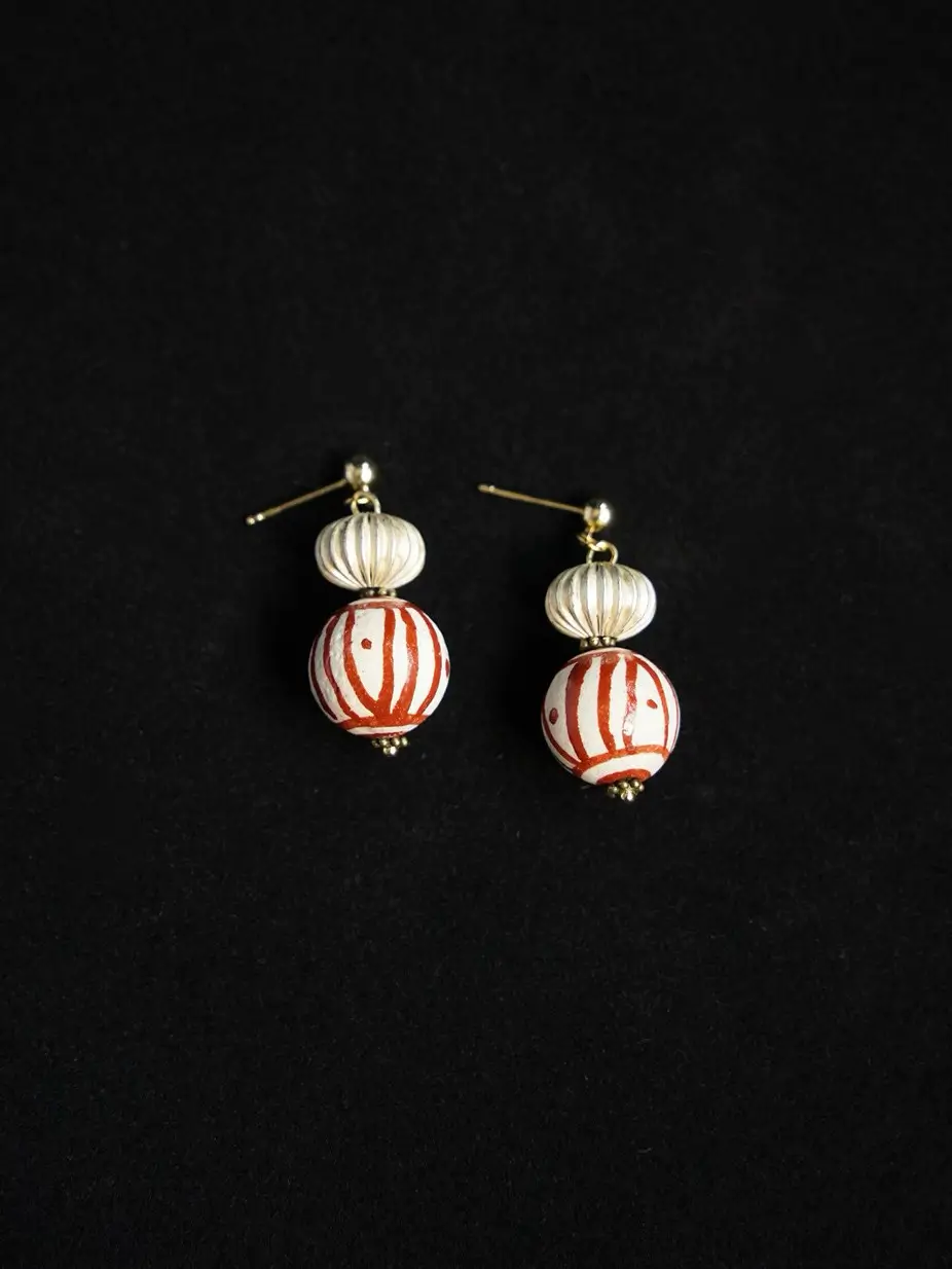 Close-up of the antique silver lantern elements on a solid black background.