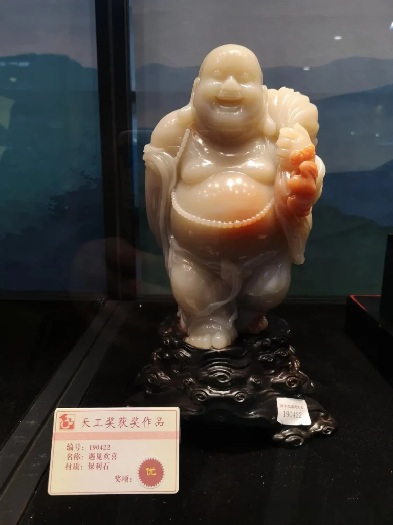A Maitreya Buddha sculpture carved from Baoli stone on display.