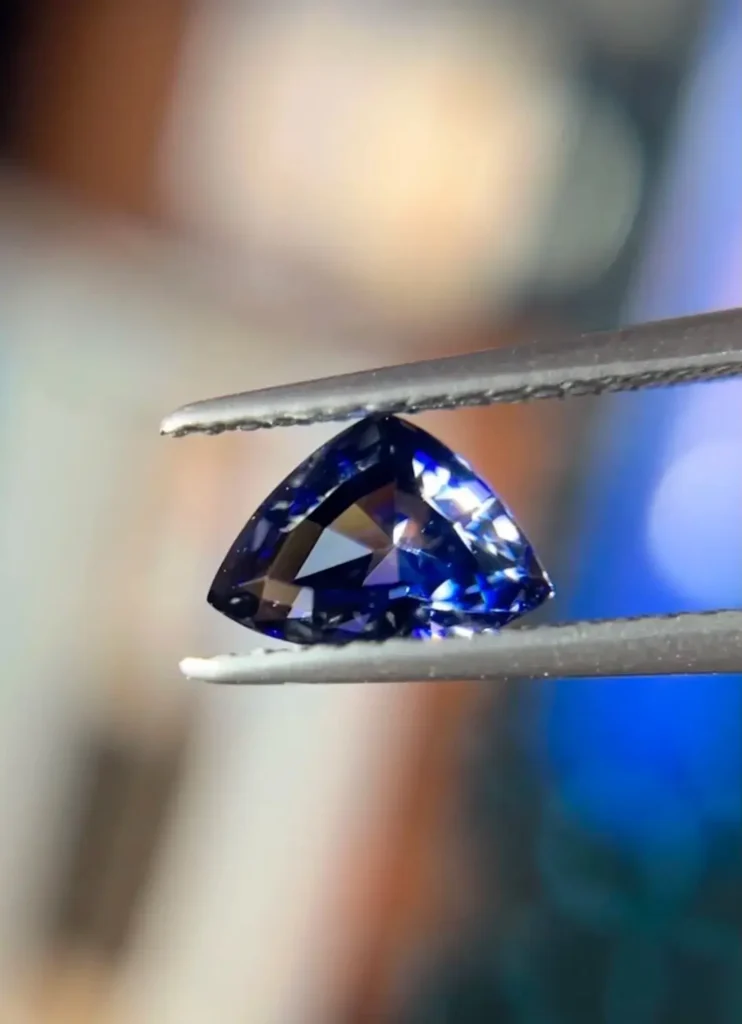 A 1.1 carat round-cut benitoite gemstone displaying intense blue color and spectral fire.