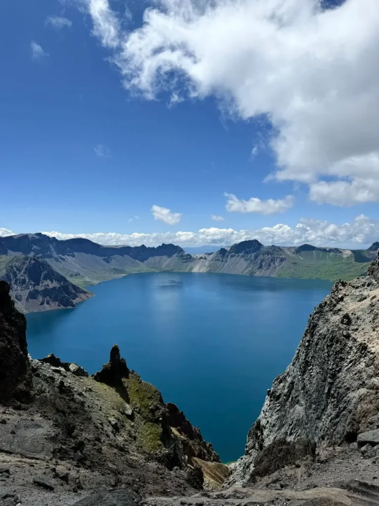 Deep blue Heaven Lake atop Mount Changbai in Jilin under a sunny sky.
