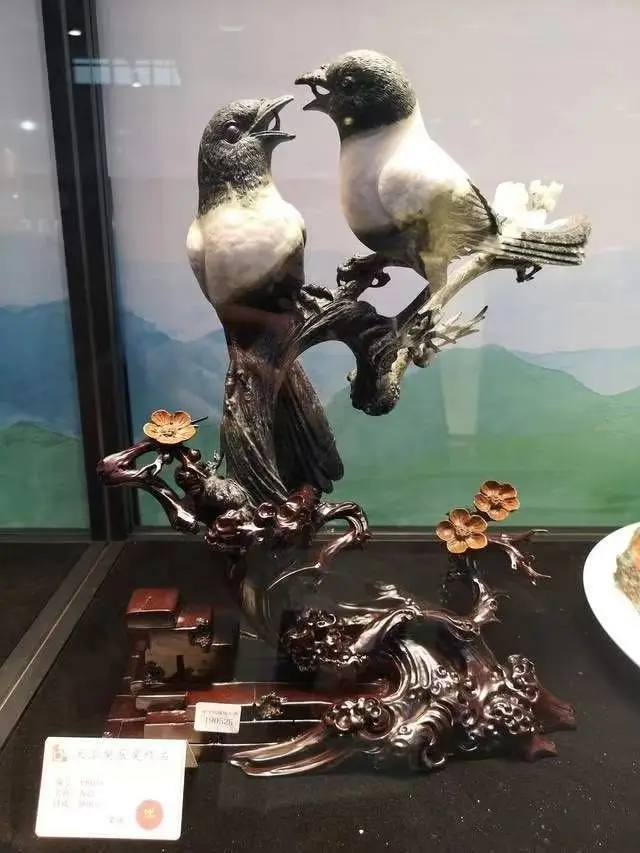 Henan Dushan Jade sculpture Spring Whispers depicting two detailed birds perched on a branch.