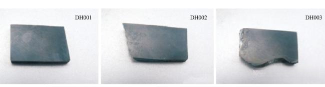 Three rectangular slabs of dark black-green Guangxi nephrite with specimen labels DH001 to DH003.