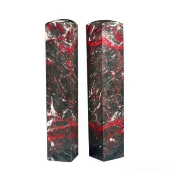 A pair of polished Guizhou chicken-blood stone seal blanks featuring crimson veins on dark matrix.