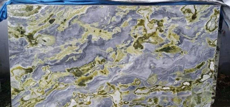 A large polished Hanzhong Jade slab with swirling purple-grey and green patterns.