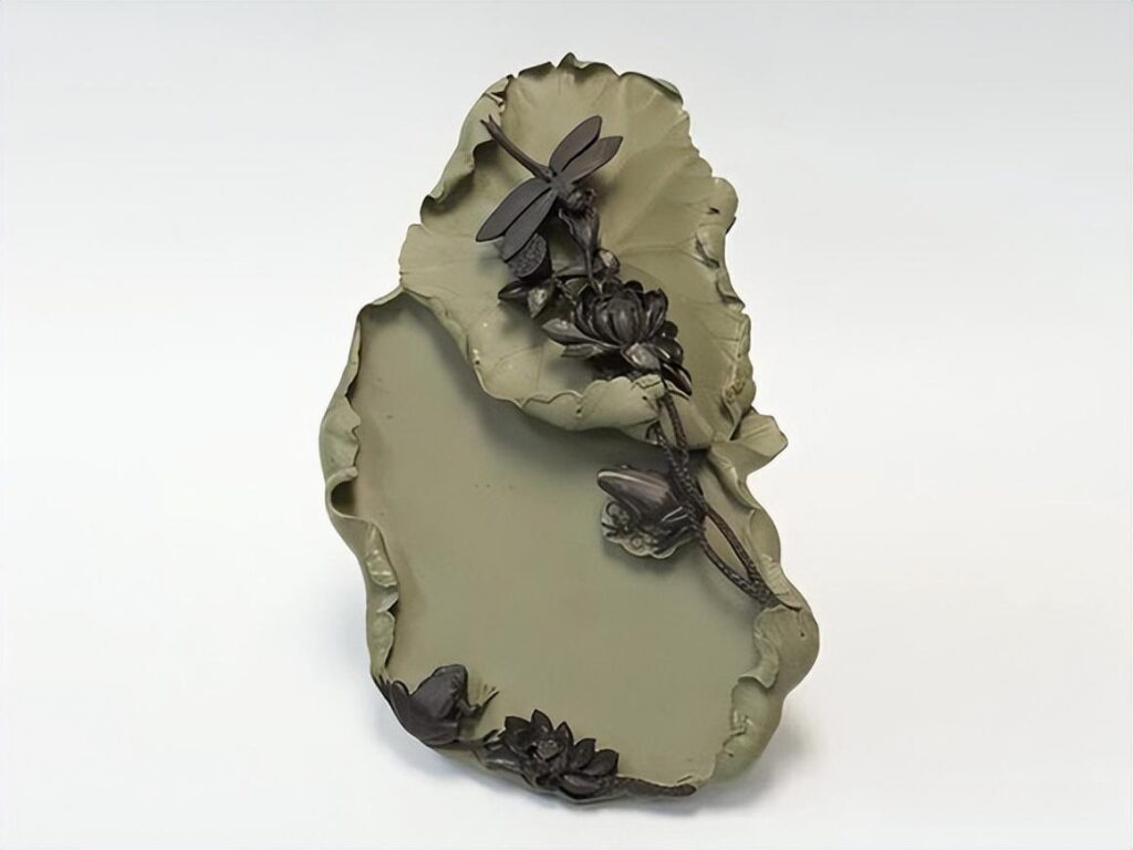 Hand-carved Helan stone inkstone featuring a lotus leaf, dragonfly, and frog motifs in green and purple.