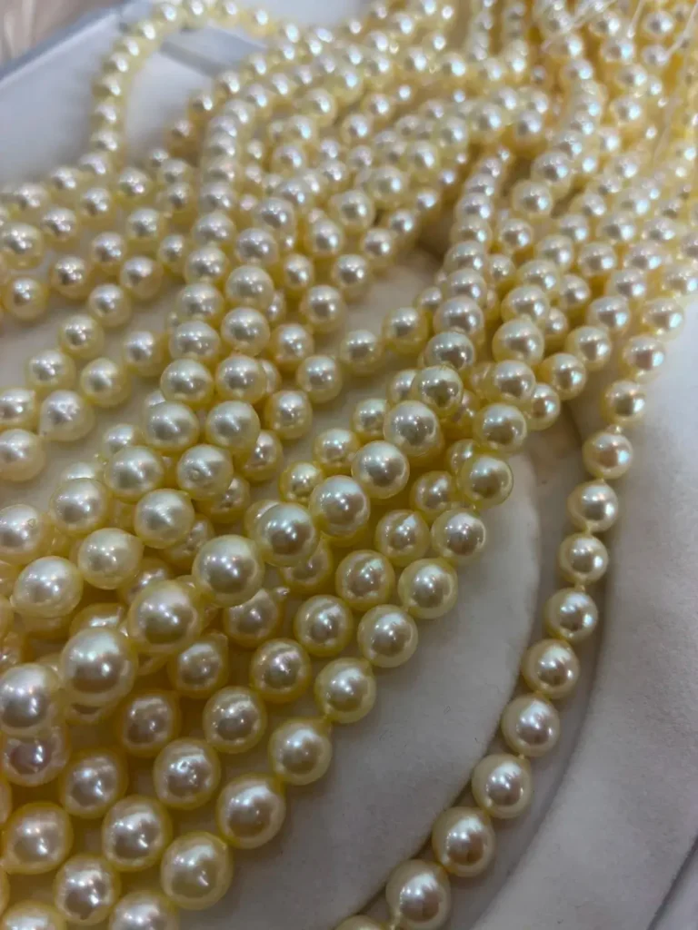 Multiple strands of round, cream-colored Hepu pearls with a high-luster mirror finish.