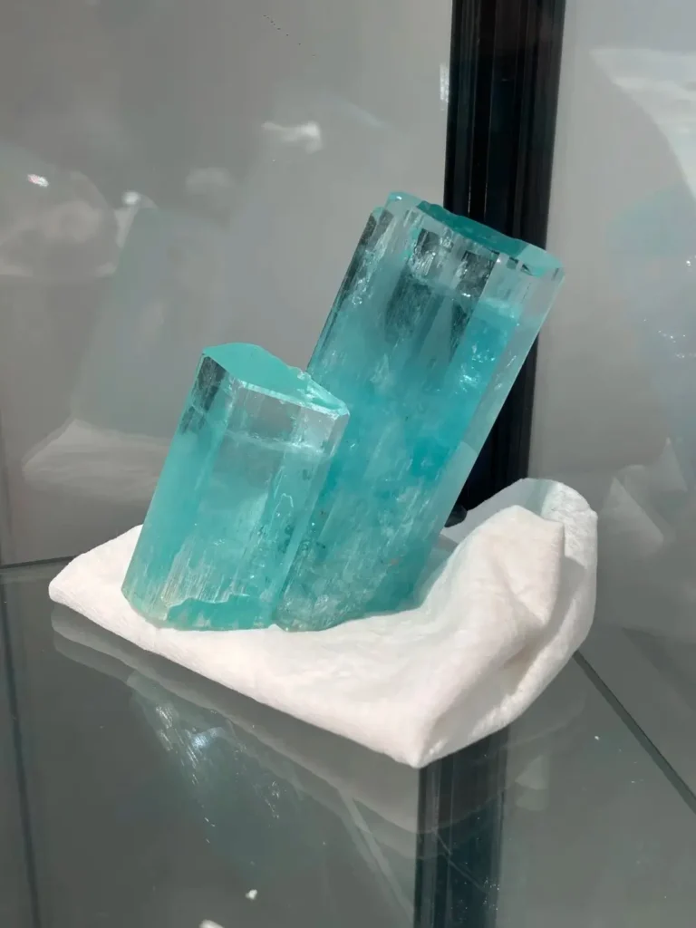 Highly transparent sea-blue aquamarine crystal pillars displayed at the Chenzhou Mineral Show.