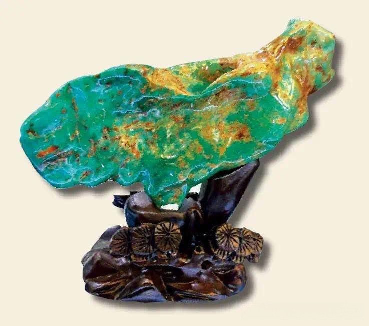 A vibrant blue-green Anhui Ma'anshan turquoise specimen with a glossy, porcelain-like luster on a stand.