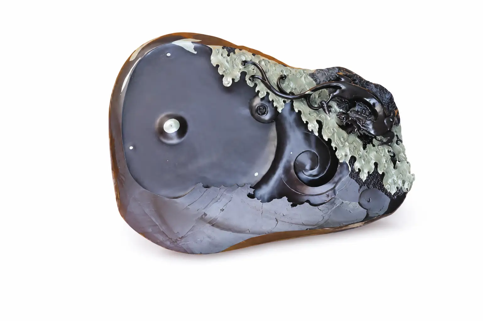 A carved Ningxia Helan stone inkstone featuring a deep black base and natural bean-green wave carvings.