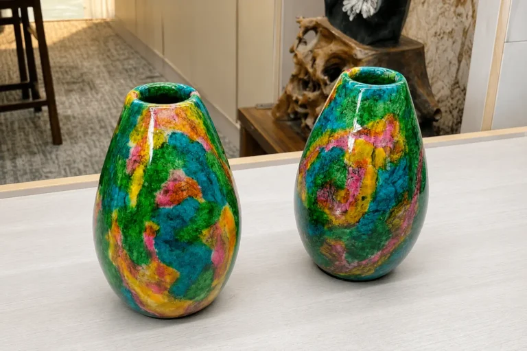 A pair of polished Taiwanese organic egg-shaped vases with bright swirled patterns of green, teal, and yellow.