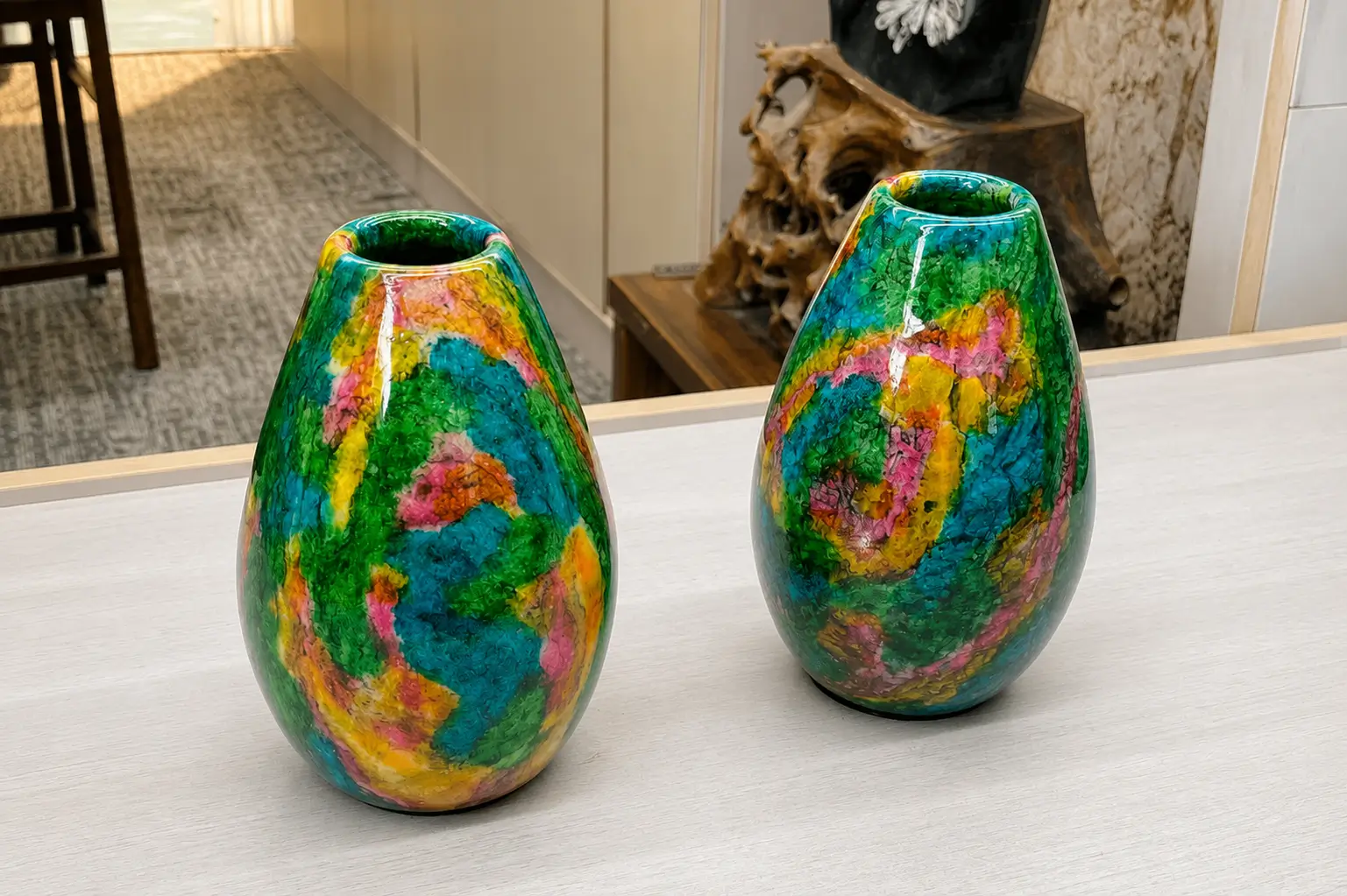 A pair of polished Taiwanese organic egg-shaped vases with bright swirled patterns of green, teal, and yellow.