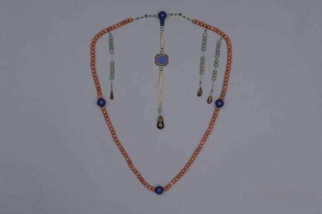 Qing Dynasty court necklace featuring pinkish-red coral beads accented with vibrant blue lapis lazuli.