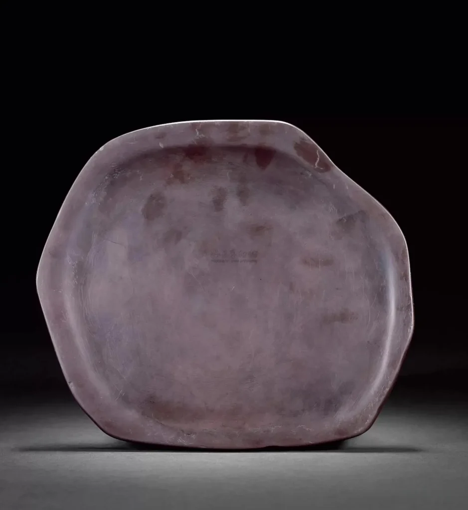 A Qing Dynasty Helan stone inkstone featuring natural deep purple and bean-green siltstone layers.