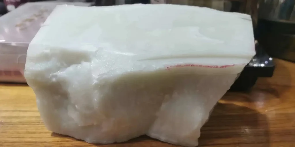 A large, blocky chunk of raw white Luodian jade with a bone-white color from Guizhou.